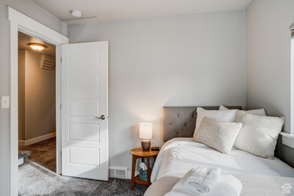 Carpeted bedroom with baseboards