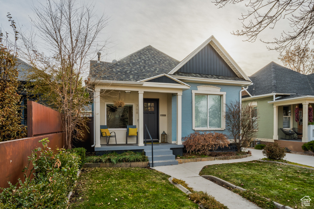Bungalow-style house featuring a porch, board and batten siding, and a shingled roof
