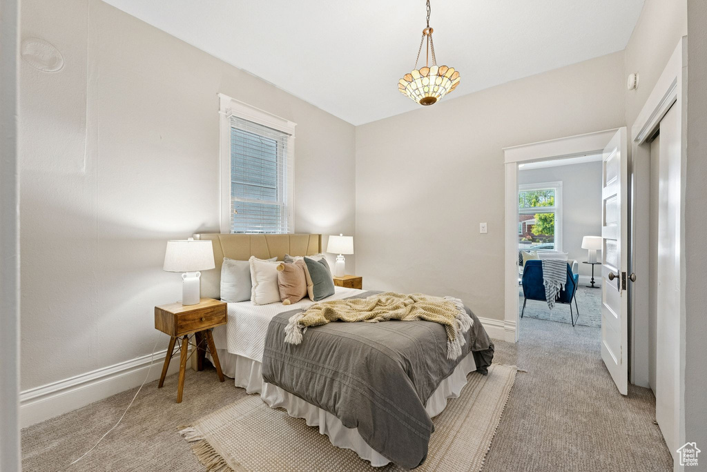 Bedroom with light carpet and baseboards