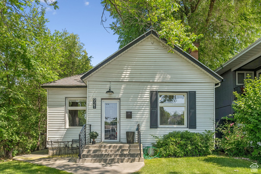 View of front of property with a front yard and a chimney
