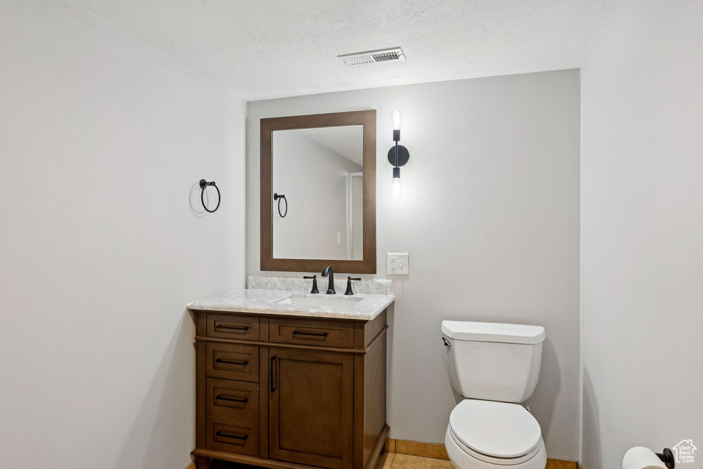 Bathroom with vanity and a textured ceiling