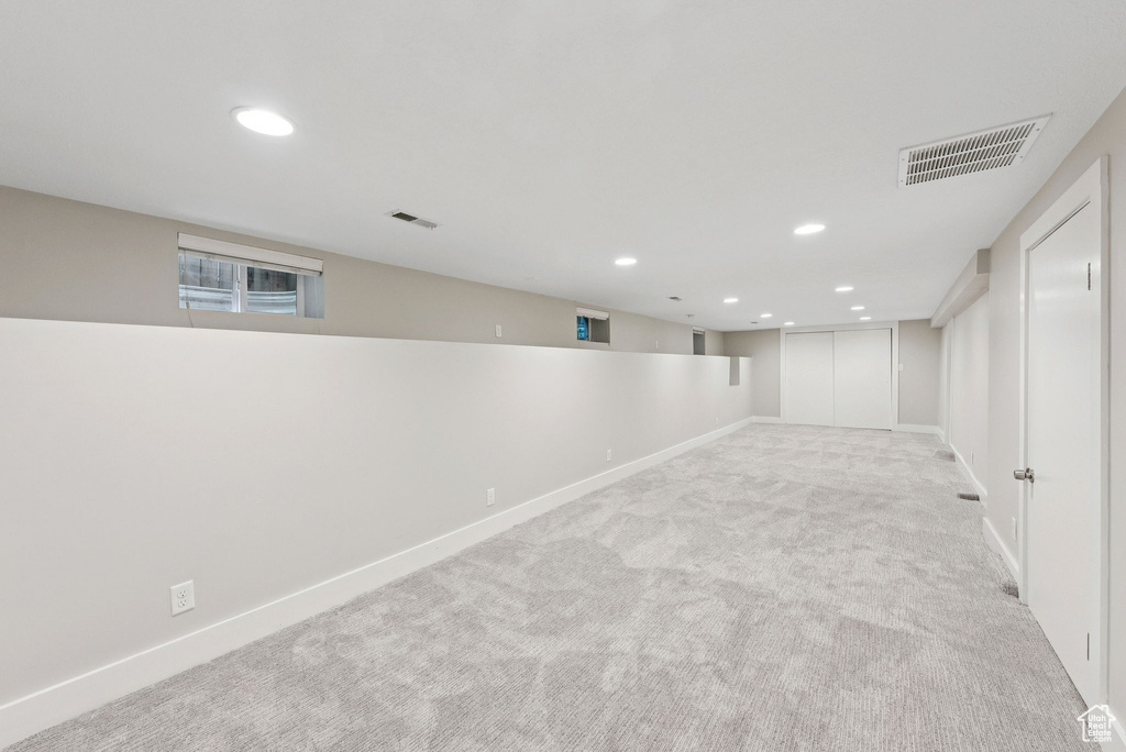 Finished basement with carpet and recessed lighting