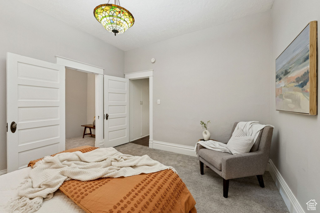 Carpeted bedroom featuring baseboards