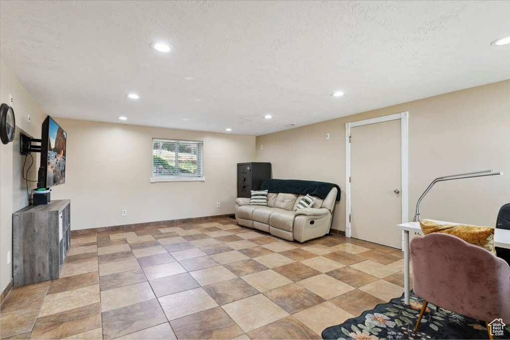 Living room featuring recessed lighting and a textured ceiling