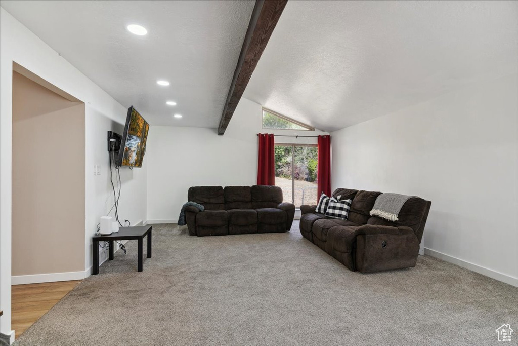 Carpeted living room featuring recessed lighting and baseboards