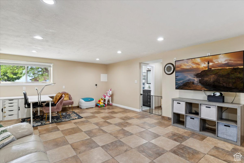 Living room featuring recessed lighting and a desk