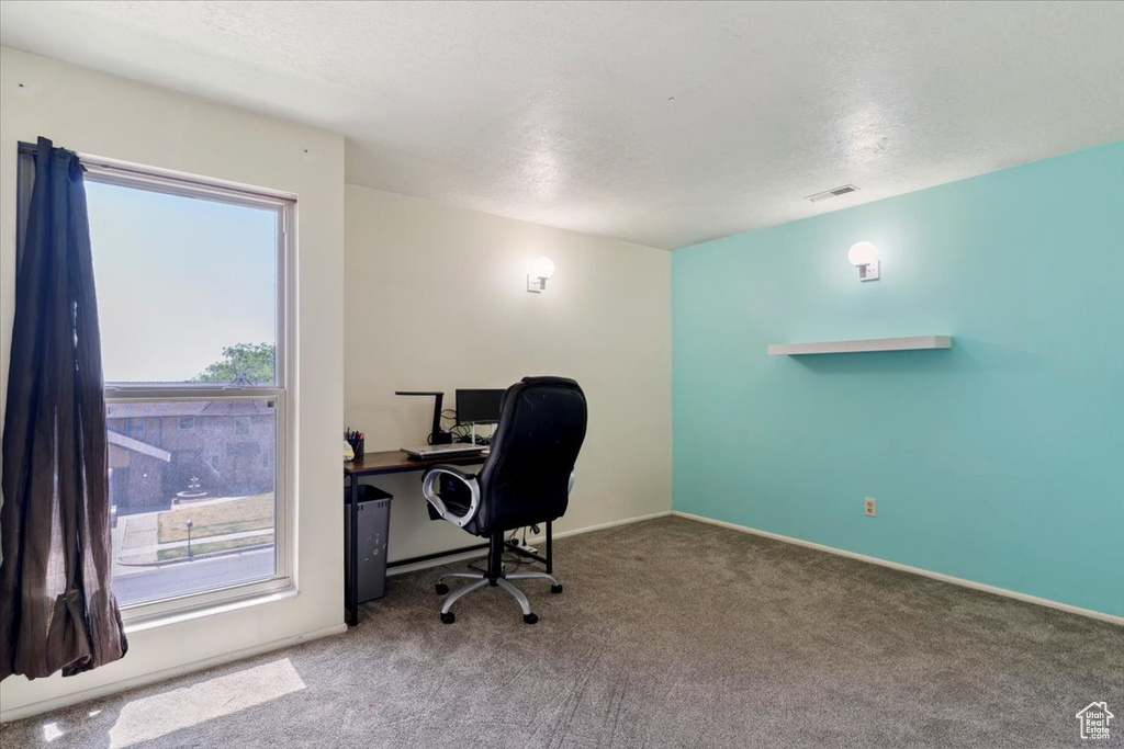 Carpeted office space featuring baseboards
