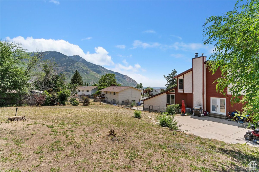 View of yard featuring a mountain view, french doors, and a patio