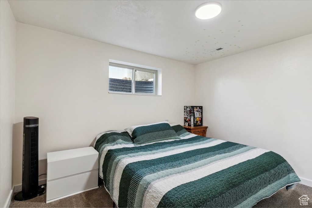 Bedroom with dark colored carpet