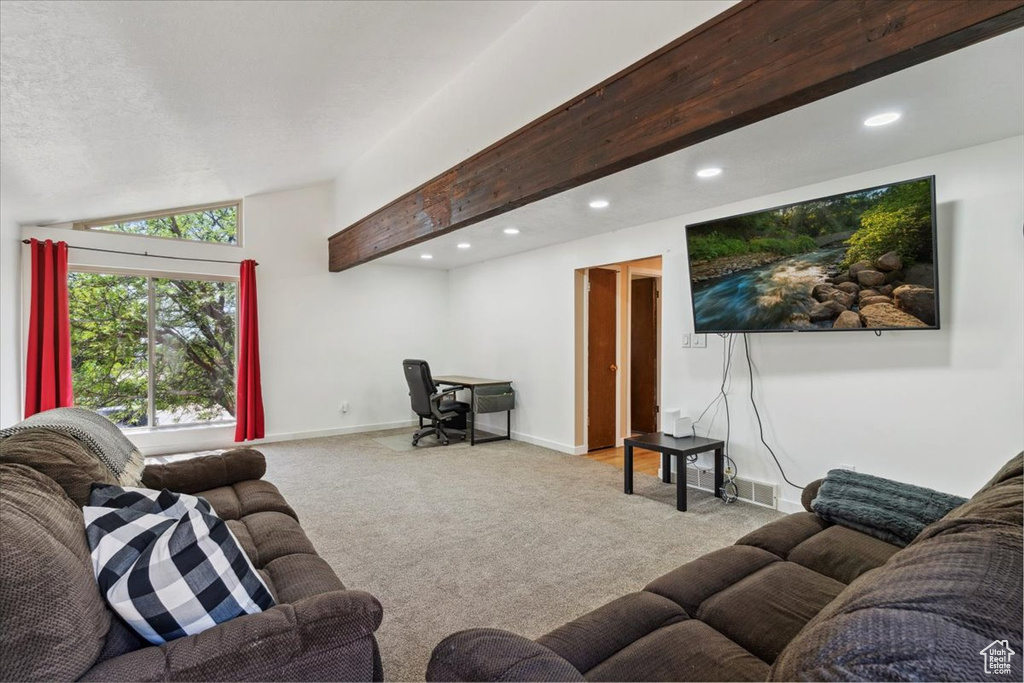 Carpeted living room featuring vaulted ceiling and recessed lighting