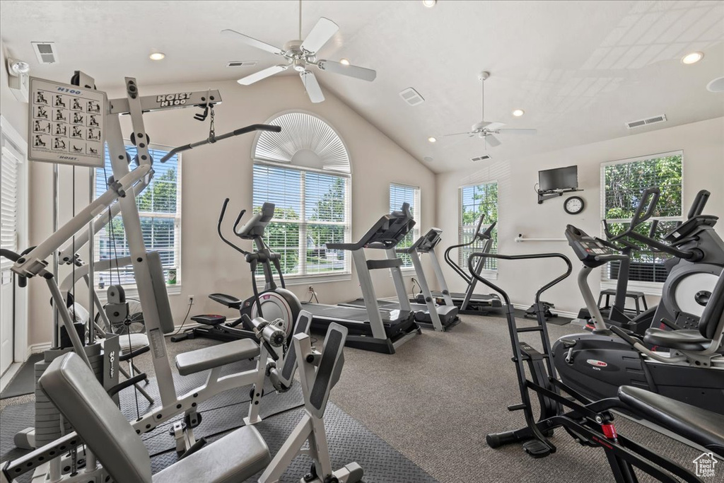 Exercise room featuring a ceiling fan, vaulted ceiling, and recessed lighting