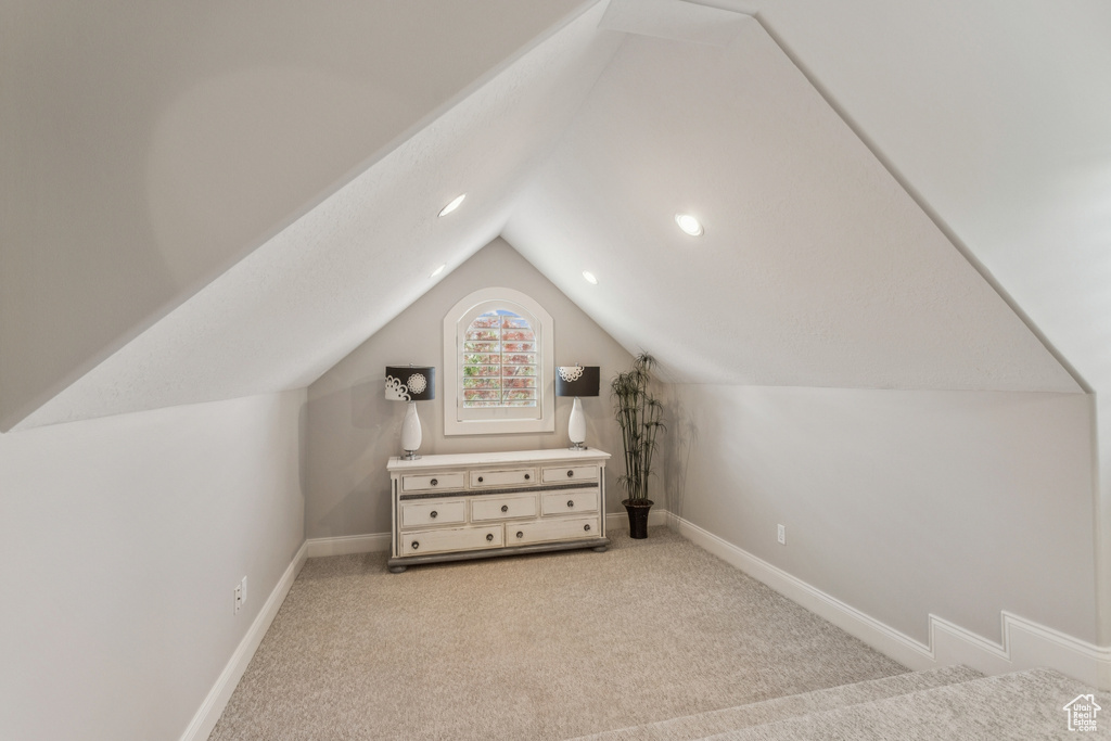 Additional living space with lofted ceiling, carpet, and recessed lighting