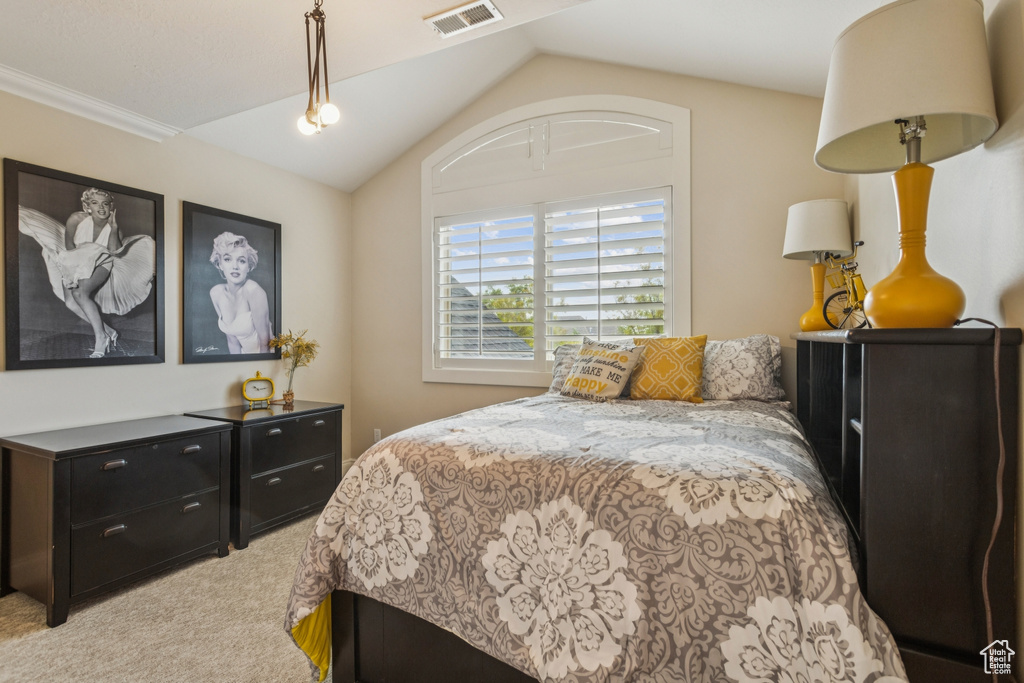 Bedroom featuring light carpet and lofted ceiling