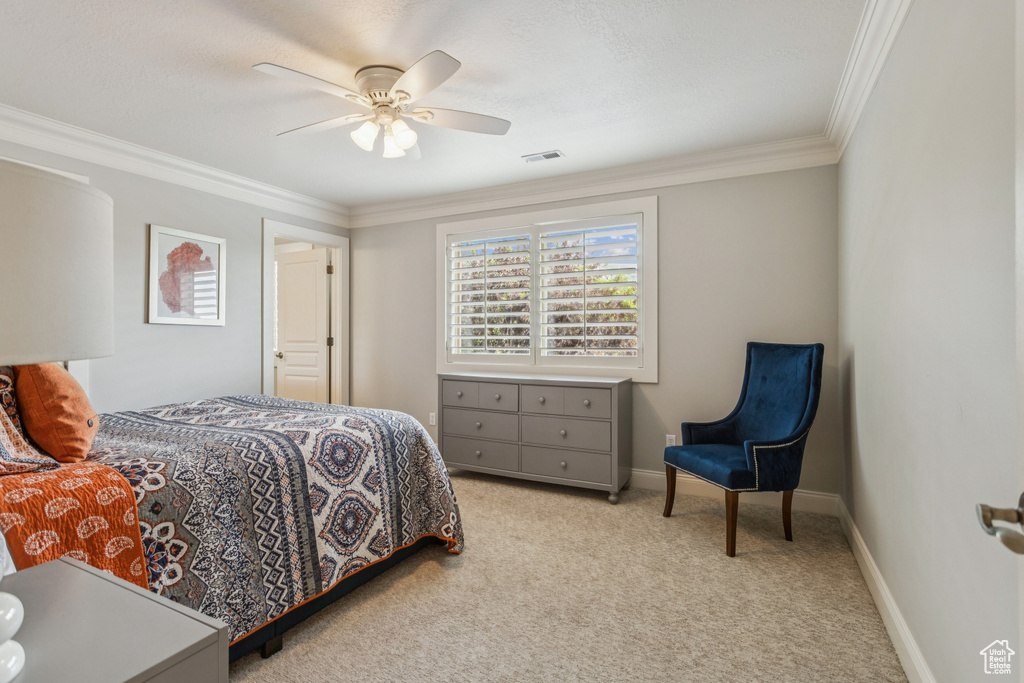 Bedroom featuring carpet flooring, crown molding, and ceiling fan
