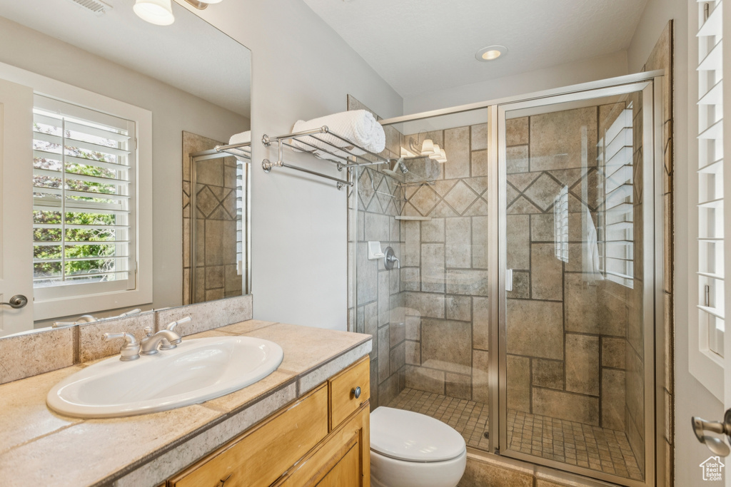 Bathroom featuring vanity and a stall shower