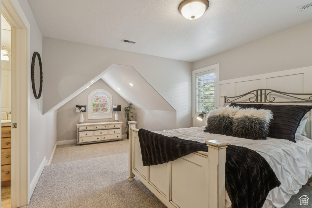 Bedroom featuring light carpet