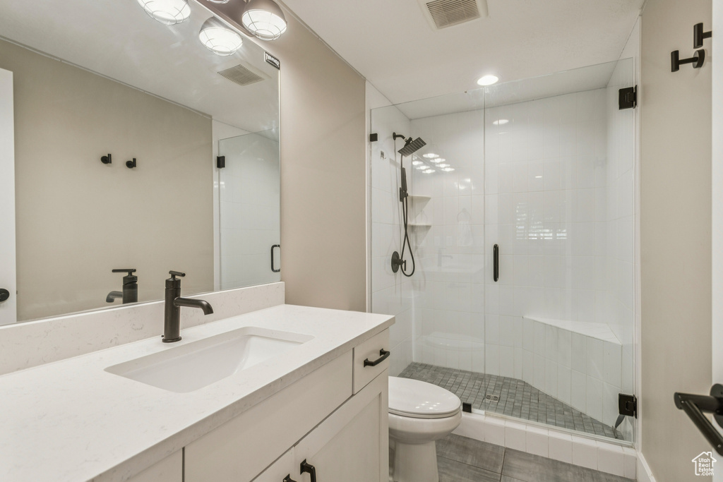 Bathroom featuring vanity, a shower stall, and recessed lighting