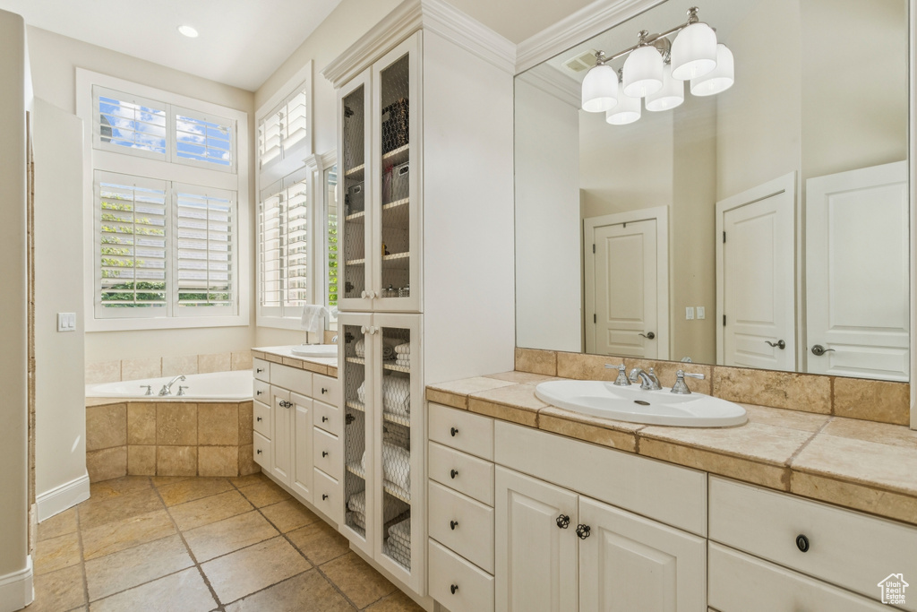 Full bathroom featuring vanity, a garden tub, tile patterned floors, and recessed lighting