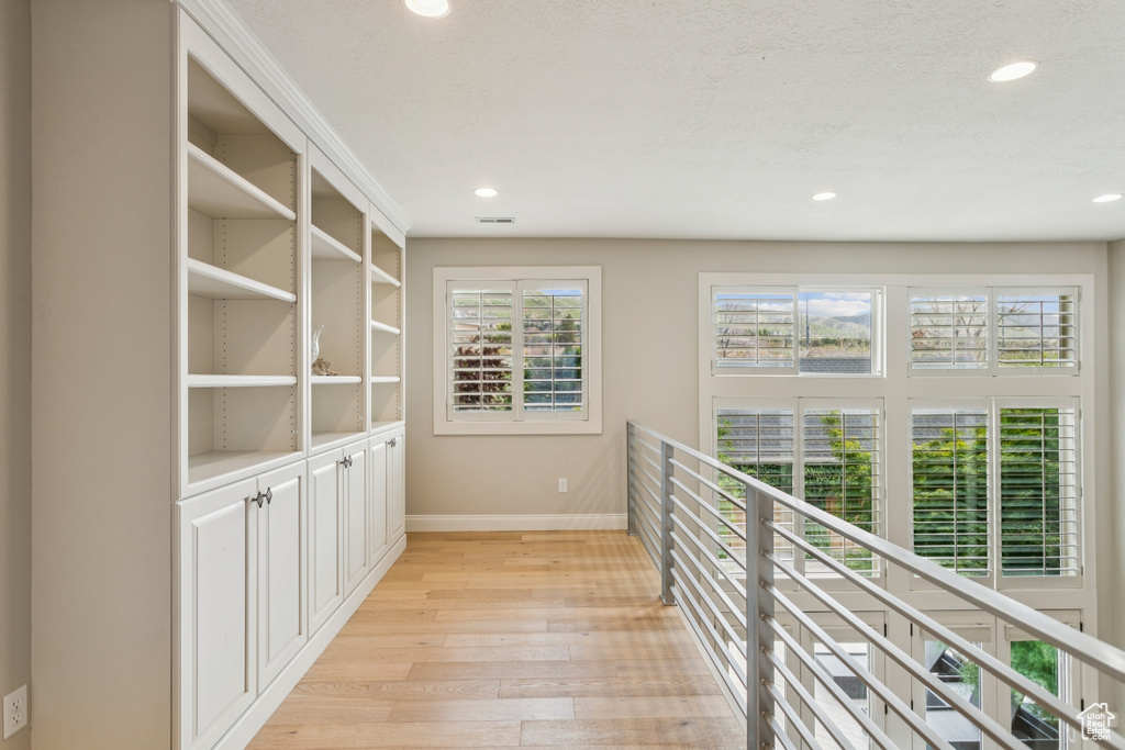 Corridor featuring light wood-style flooring and recessed lighting