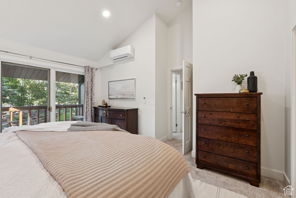 Bedroom featuring a wall mounted AC, light colored carpet, access to exterior, and high vaulted ceiling
