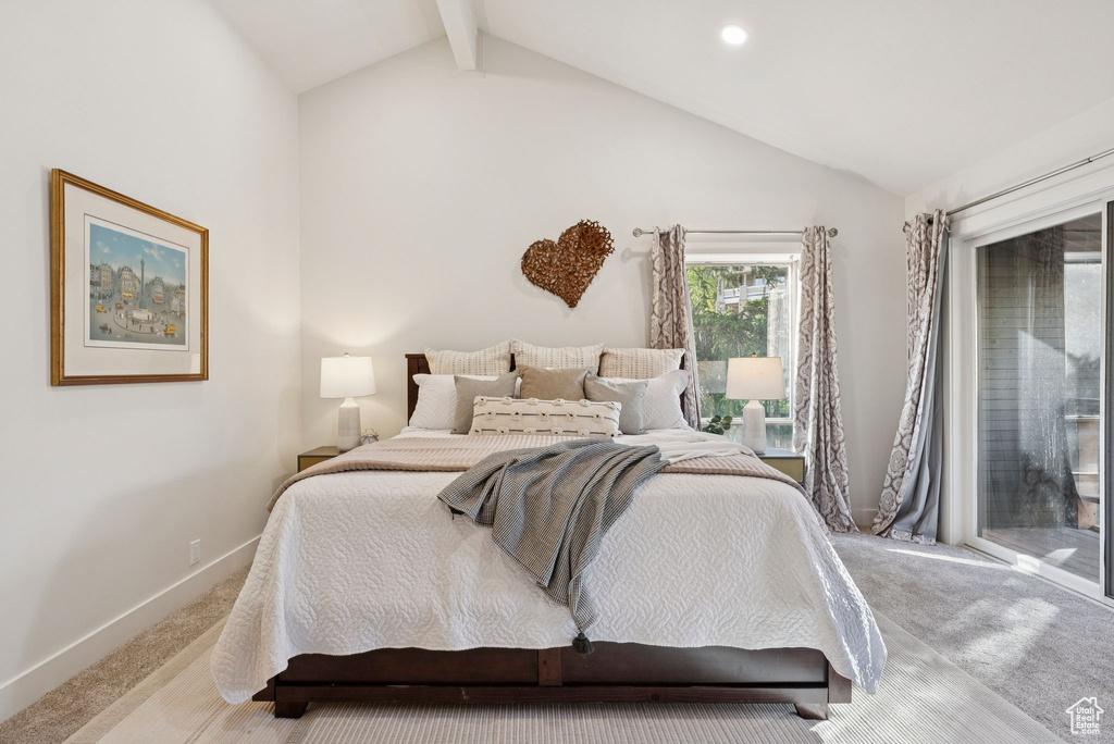 Carpeted bedroom with access to exterior and baseboards