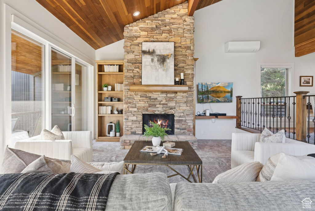 Living room with wood ceiling, a wall mounted air conditioner, high vaulted ceiling, and a fireplace