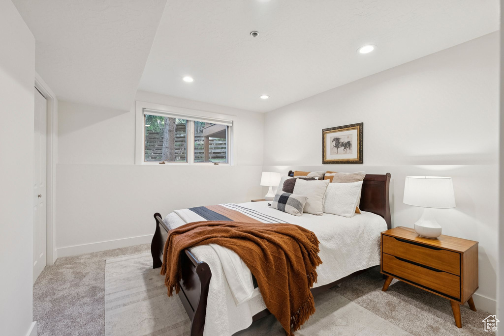 Carpeted bedroom with recessed lighting