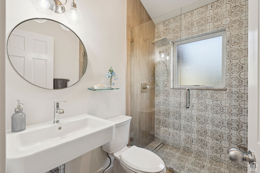 Bathroom featuring a sink and tiled shower