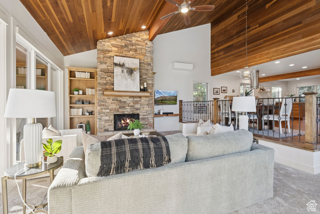 Living area with carpet flooring, wooden ceiling, ceiling fan, high vaulted ceiling, and a stone fireplace