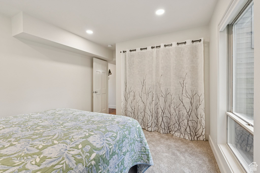 Carpeted bedroom with recessed lighting