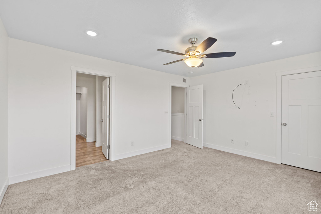 Unfurnished bedroom featuring carpet, recessed lighting, ceiling fan, and ensuite bath