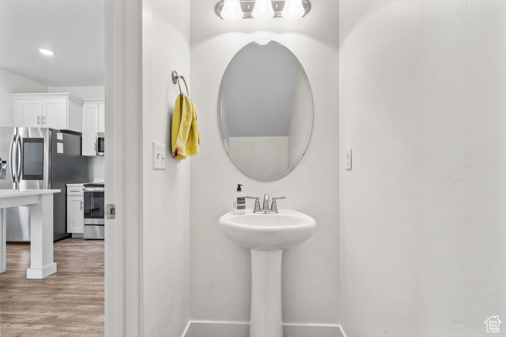 Bathroom with baseboards and wood finished floors