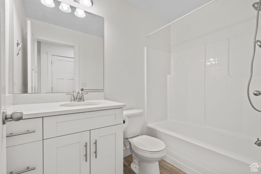 Full bathroom featuring vanity, bathtub / shower combination, and wood finished floors