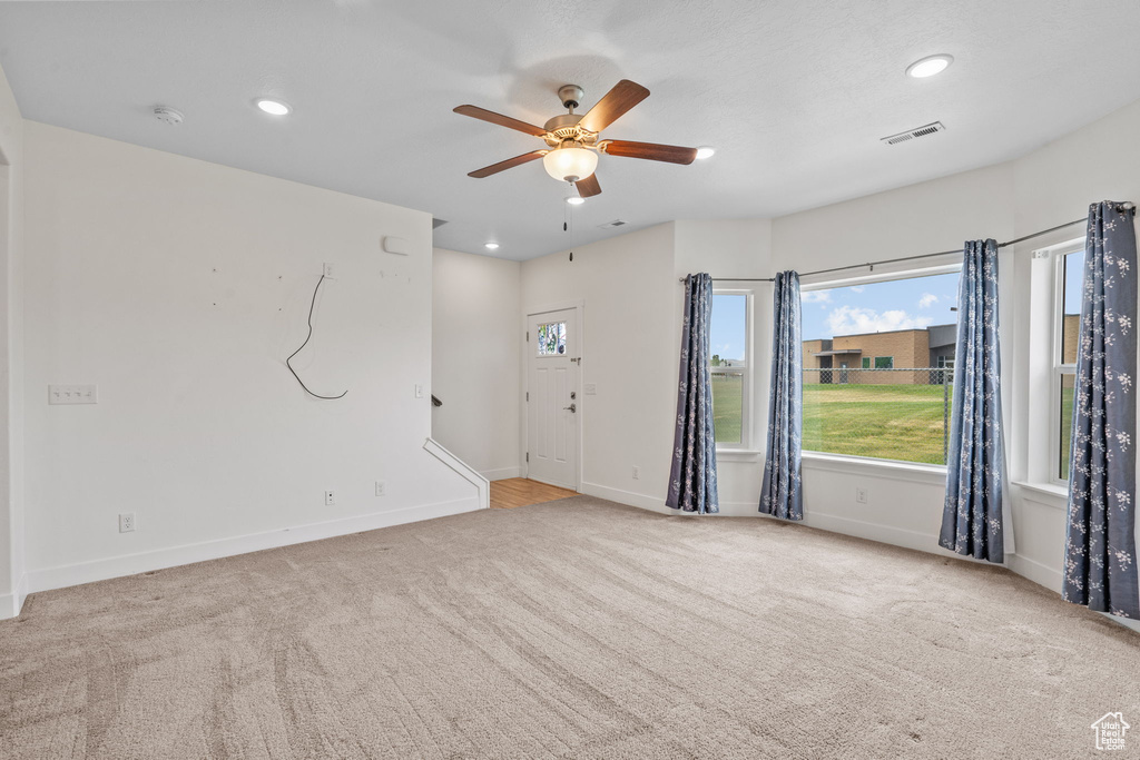Unfurnished room with ceiling fan, carpet floors, plenty of natural light, recessed lighting, and a smoke detector