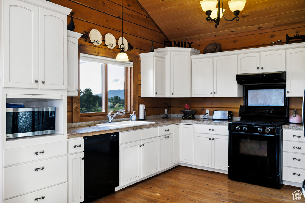 Kitchen featuring black appliances, exhaust hood, vaulted ceiling, white cabinets, and wooden ceiling