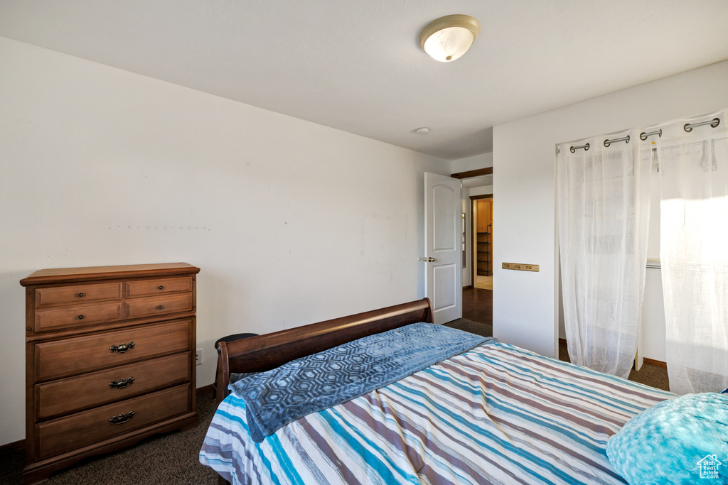 Bedroom with dark colored carpet