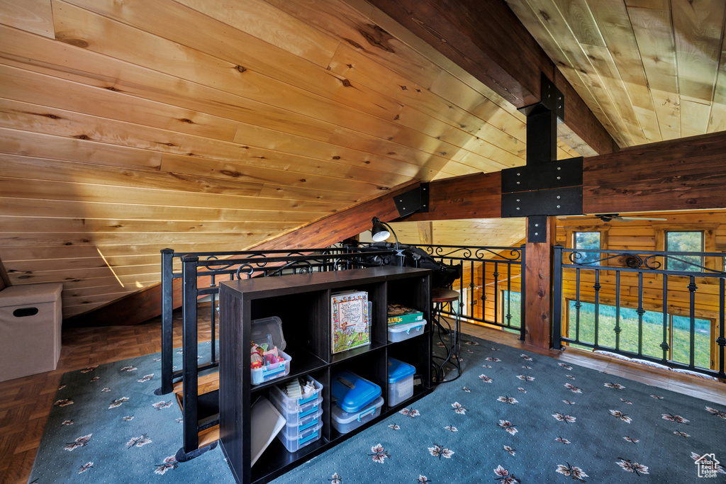 Bedroom featuring wooden ceiling, vaulted ceiling, and wooden walls