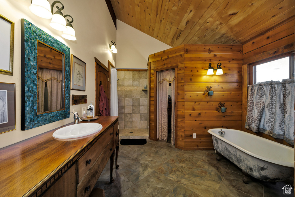 Bathroom featuring wood ceiling, vanity, a tile shower, a freestanding bath, and vaulted ceiling
