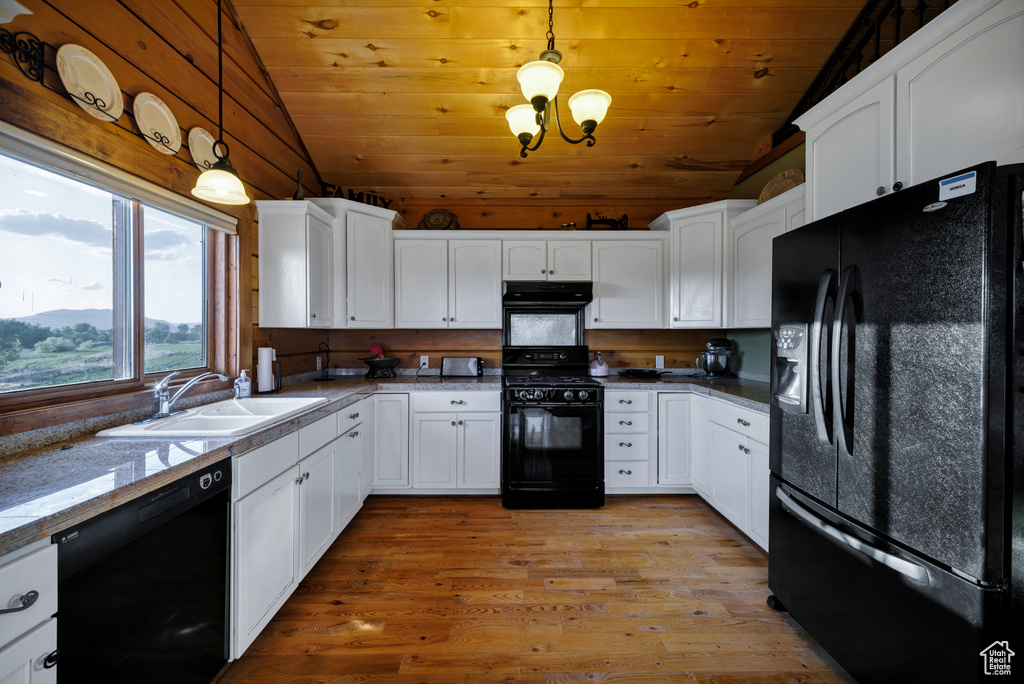 Kitchen featuring black appliances, vaulted ceiling, exhaust hood, wooden ceiling, and white cabinets