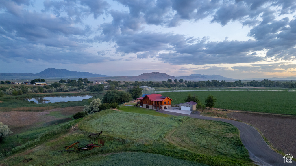 View of mountain backdrop featuring rural landscape and a nearby body of water