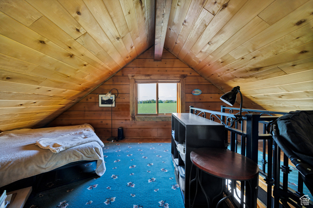 Carpeted bedroom featuring wood walls, lofted ceiling, and wooden ceiling