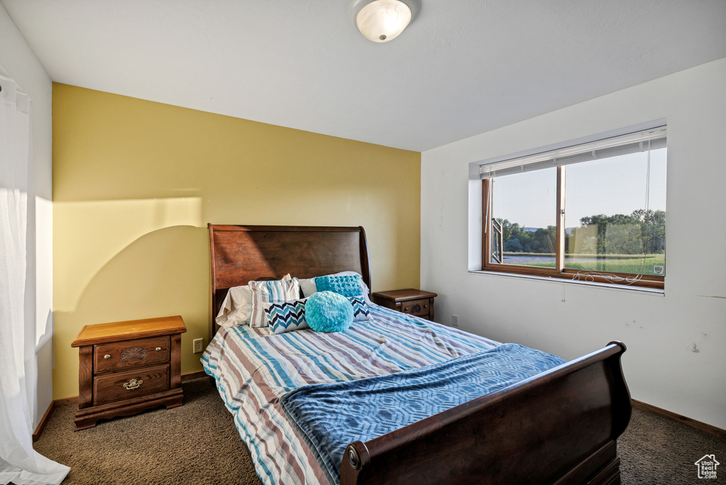 Carpeted bedroom with baseboards