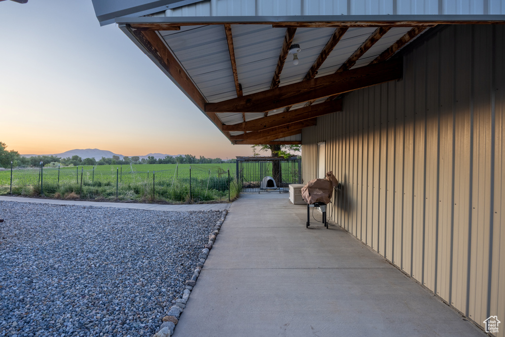 View of patio with a mountain view, a rural view, and grilling area