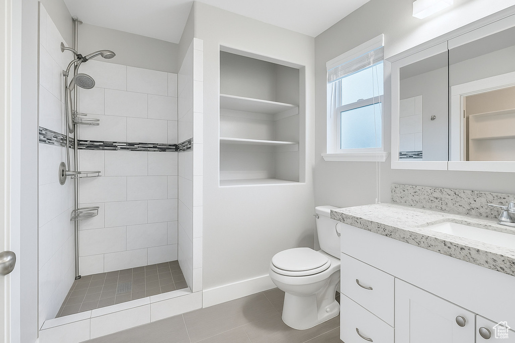 Bathroom featuring vanity and a tile shower