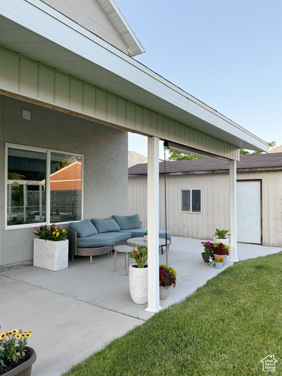 View of patio with an outdoor structure and an outdoor living space