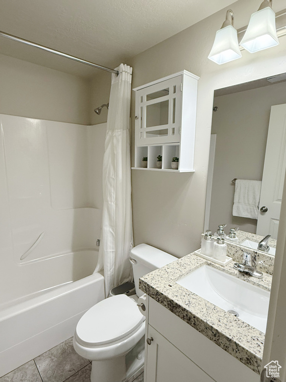 Full bathroom with shower / tub combo, vanity, and tile patterned flooring
