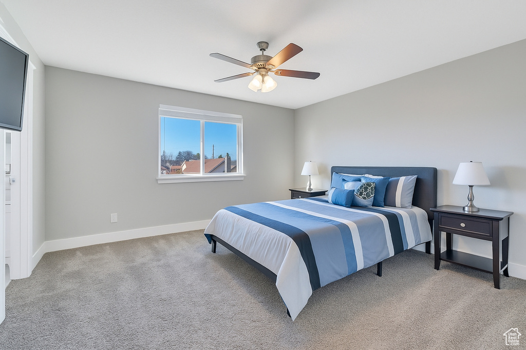 Bedroom featuring light colored carpet and a ceiling fan