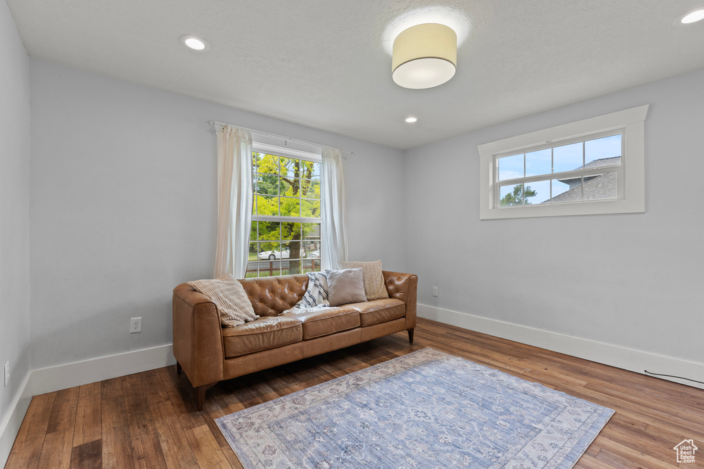 Sitting room featuring plenty of natural light, wood finished floors, and recessed lighting
