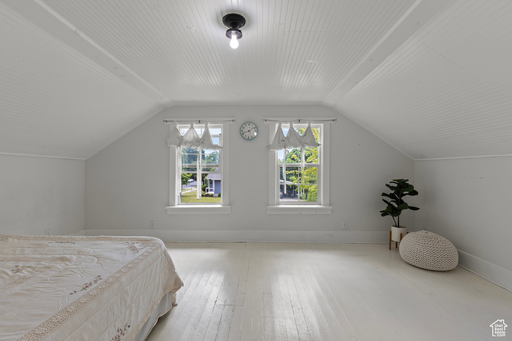 Bedroom featuring vaulted ceiling and hardwood / wood-style flooring
