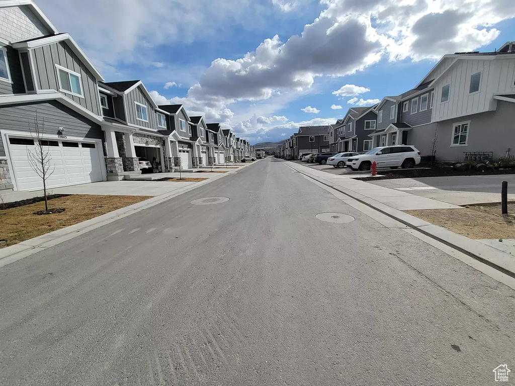 View of asphalt road featuring a residential view